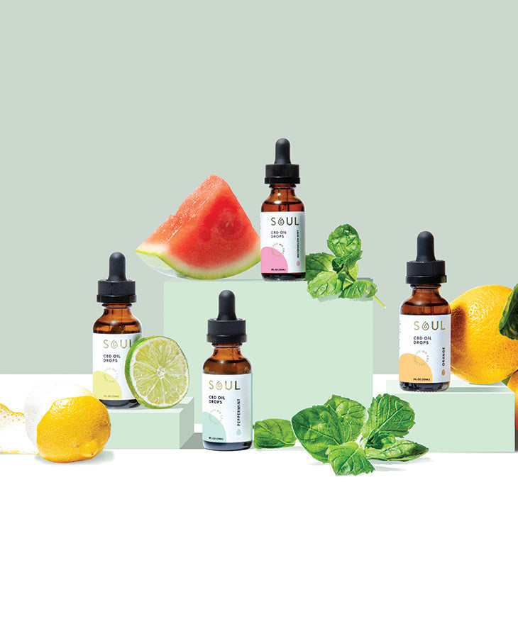 Front view of Soul CBD oil droppers showing flavored labels with watermelon, lime, lemon, and mint on pale green background