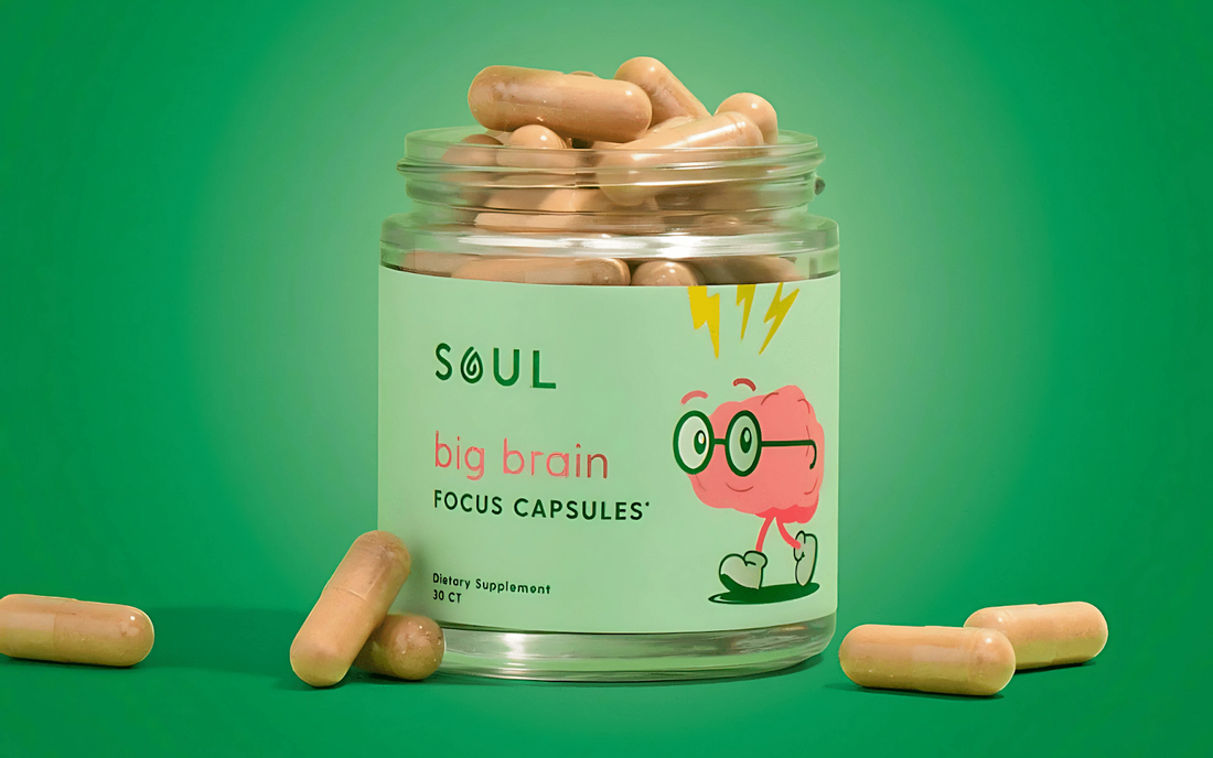 Front view of SOUL Big Brain focus capsules jar showcasing beige capsules and playful label artwork on a green background