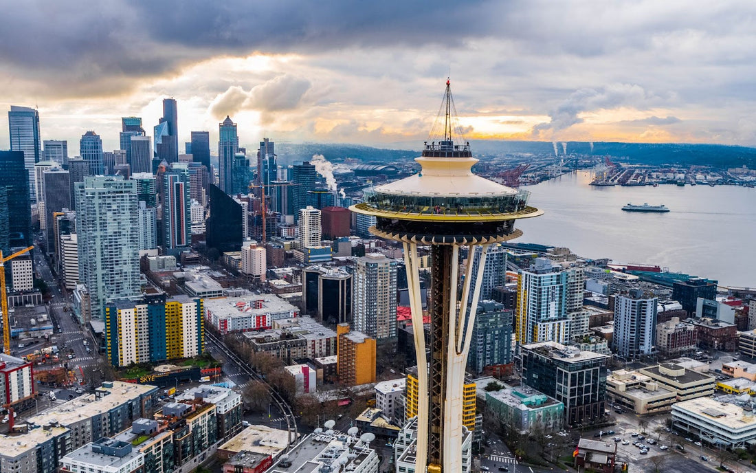 Space Needle overlooking downtown Seattle skyline and Elliott Bay at sunset