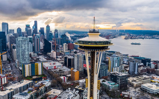 Space Needle overlooking downtown Seattle skyline and Elliott Bay at sunset