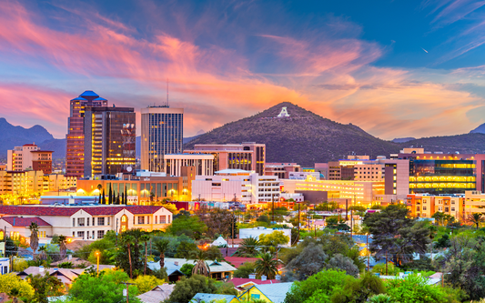 Tucson skyline at sunset with downtown buildings and the white A on Sentinel Peak