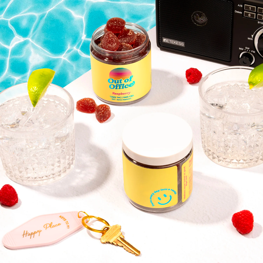 Overhead of open Out of Office Raspberry gummy jar showing sugar-coated red gummies with pool-pattern backdrop and two ice-filled glasses with lime