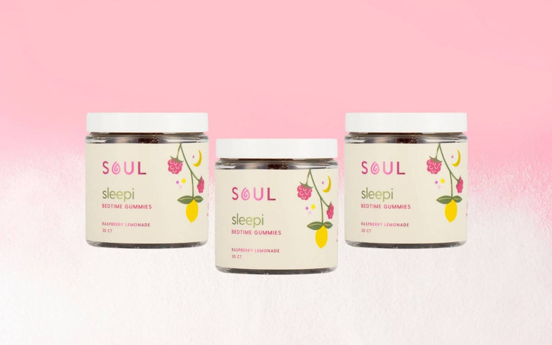 Front view of three Soul Sleepi bedtime gummies jars showing raspberry lemonade labels and white lids on a pink gradient background