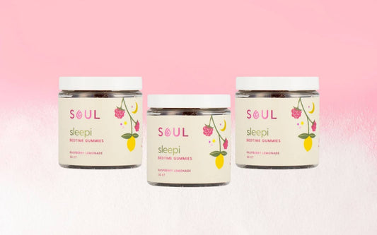 Front view of three Soul Sleepi bedtime gummies jars showing raspberry lemonade labels and white lids on a pink gradient background