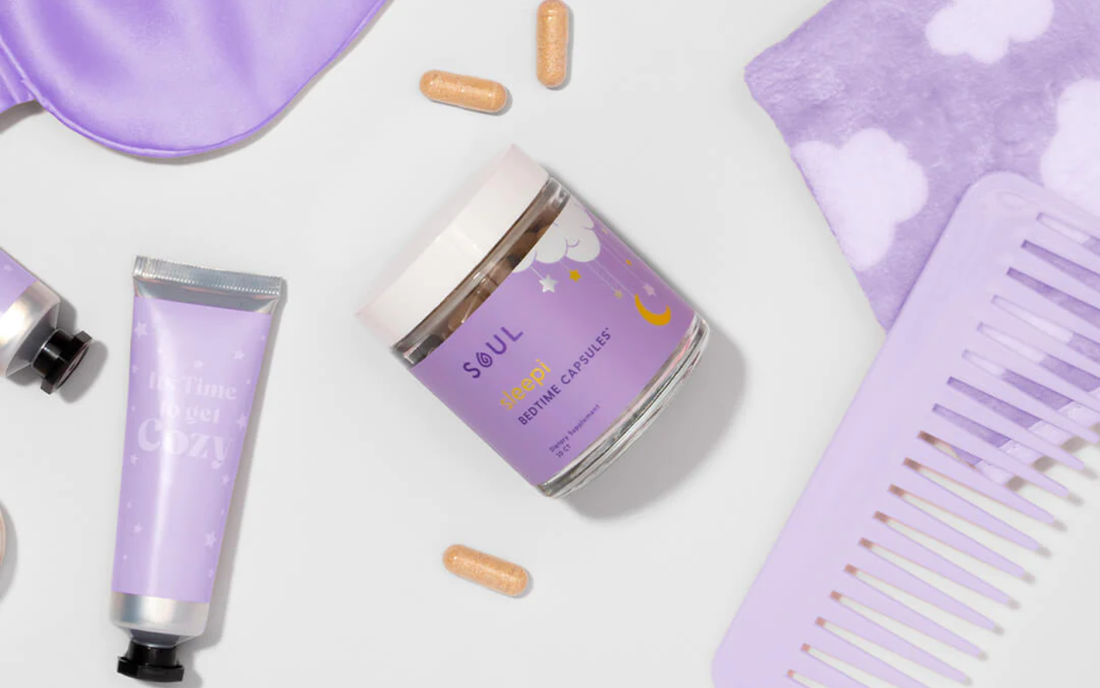 Angled top-down view of Soul Sleepi bedtime capsules jar showing purple label and two capsules with lavender sleep accessories on white