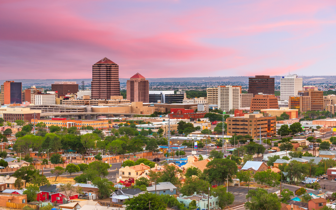 Downtown Albuquerque skyline at sunset with pink clouds
