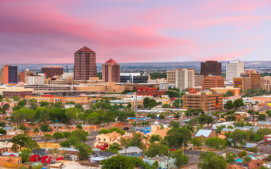 Downtown Albuquerque skyline at sunset with pink clouds