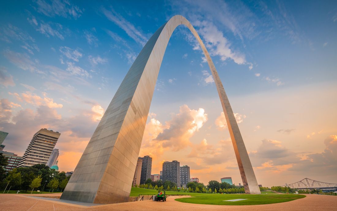 Gateway Arch towering over the St. Louis skyline at sunset