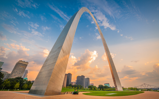 Gateway Arch towering over the St. Louis skyline at sunset