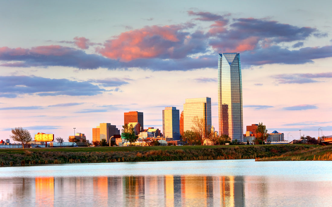 Oklahoma City skyline at sunset reflected in a river
