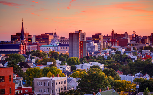 Portland, Maine skyline at sunset with a prominent church steeple and residential foreground