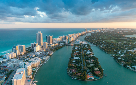 Aerial view of Florida coastline and intracoastal waterway with beachfront high-rise buildings at sunset