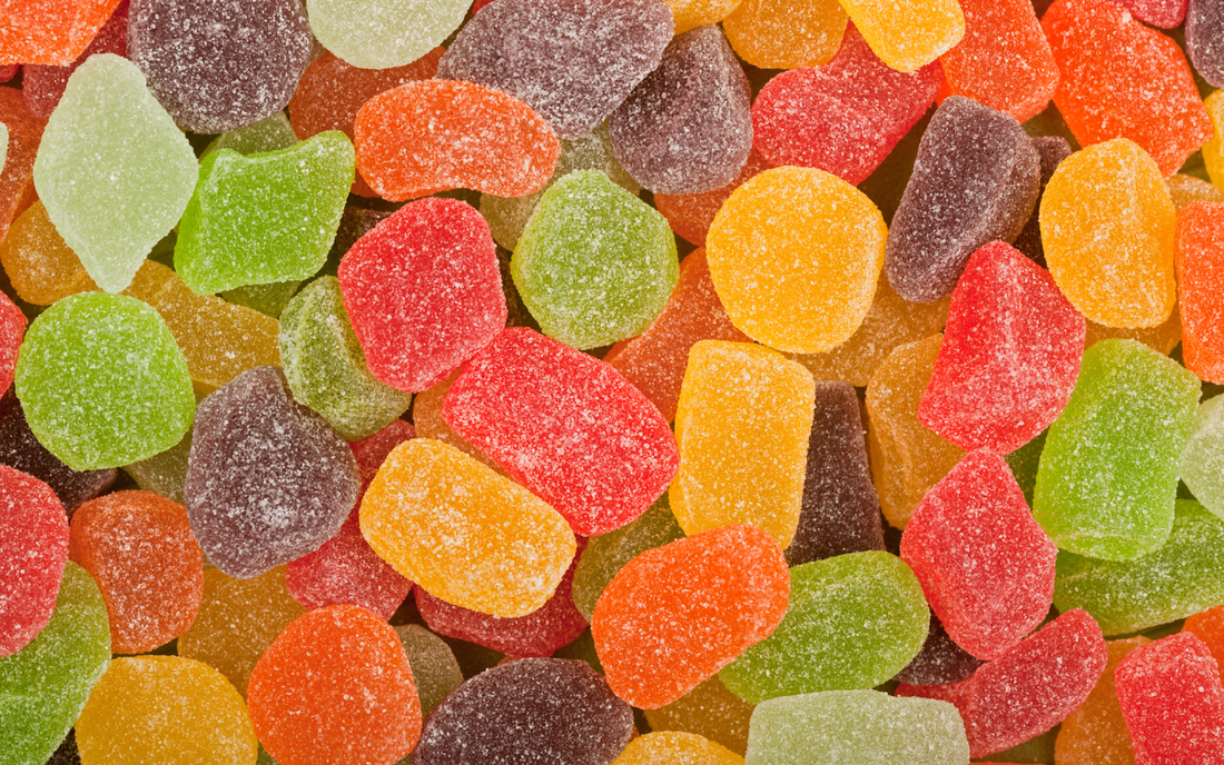 Close-up of multicolored sugar-coated gummy candies filling the frame