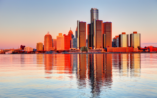 Detroit skyline at sunset reflected in the Detroit River