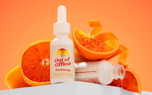 Front view of Out of Office Blood Orange dropper bottle showcasing label text with blood orange slices on an orange background