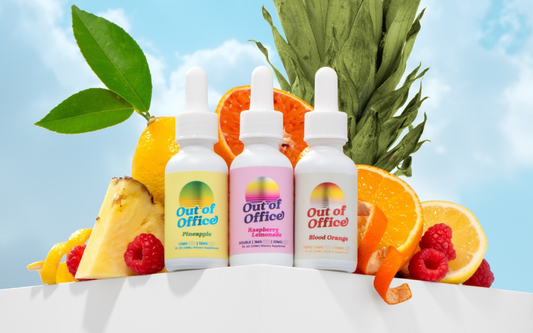 Three Out of Office dropper bottles labeled Pineapple, Raspberry Lemonade and Blood Orange with sliced fruit and sky