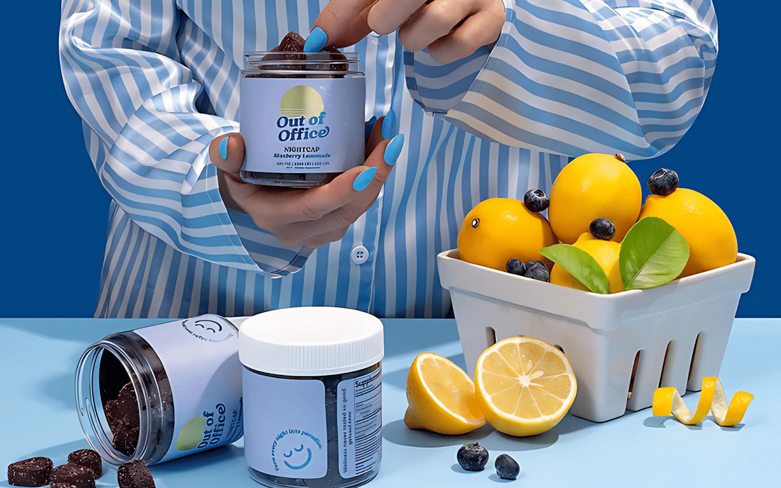 Person in blue striped shirt holding a jar labeled Out of Office gummies over a table with jars, sliced lemon, and blueberries
