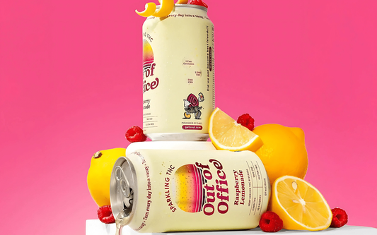 Angled front view of Out of Office Raspberry Lemonade THC can showcasing the label with fresh lemons and raspberries on a bright pink background