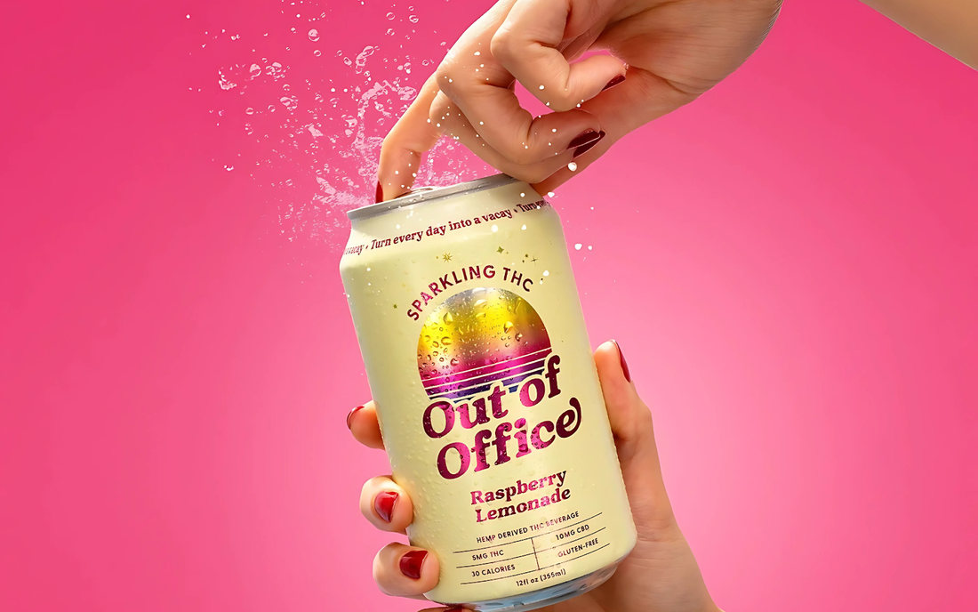 Hand opening a can of Out of Office Raspberry Lemonade sparkling THC drink with pink background and splash