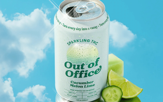 Close-up of Out of Office sparkling THC can labeled Cucumber Melon Lime with condensation and lime and cucumber slices on blue