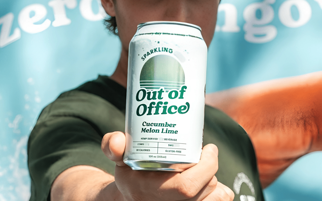 Close up of Out of Office sparkling can, Cucumber Melon Lime, 12 fl oz, held to camera against a blurred teal background