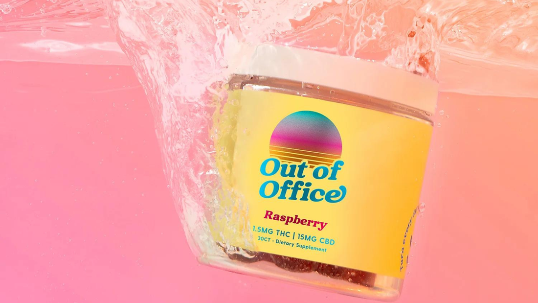 Tilted jar of Out of Office Raspberry gummies with label 1.5 mg THC and 15 mg CBD against pink background with water splash