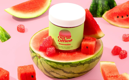 Front view of Out of Office Watermelon gummy jar displaying sugar-coated gummies in a halved watermelon on pink background