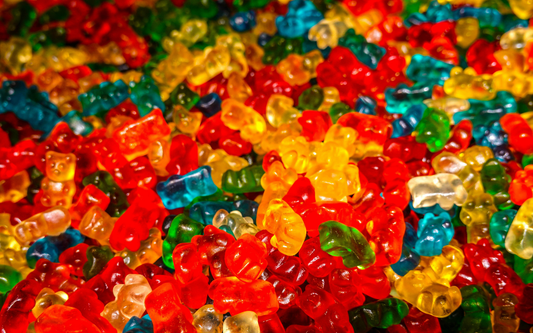 Close-up of assorted colorful gummy bears piled together