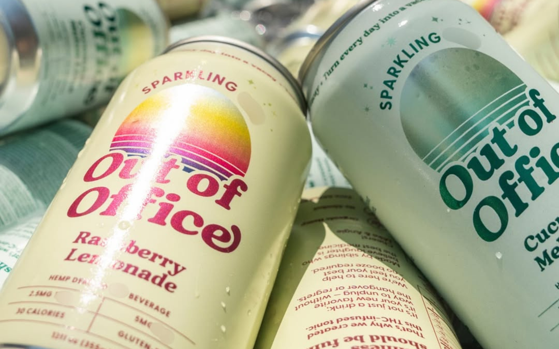 Close-up of Out of Office seltzer cans showing colorful labels and flavors Raspberry Lemonade and Cucumber Melon on overlapping cans