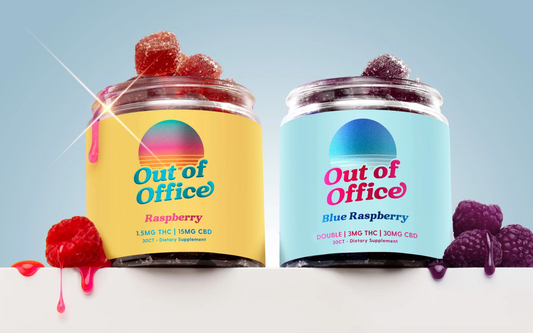 Close-up of two Out of Office gummy jars showcasing sugar-coated raspberry and blue raspberry gummies overflowing with a pale blue background