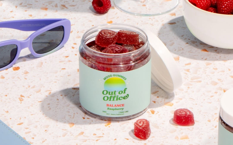 Front view of Out of Office Balance Raspberry mood gummies jar showcasing red sugar-coated gummies on a terrazzo countertop