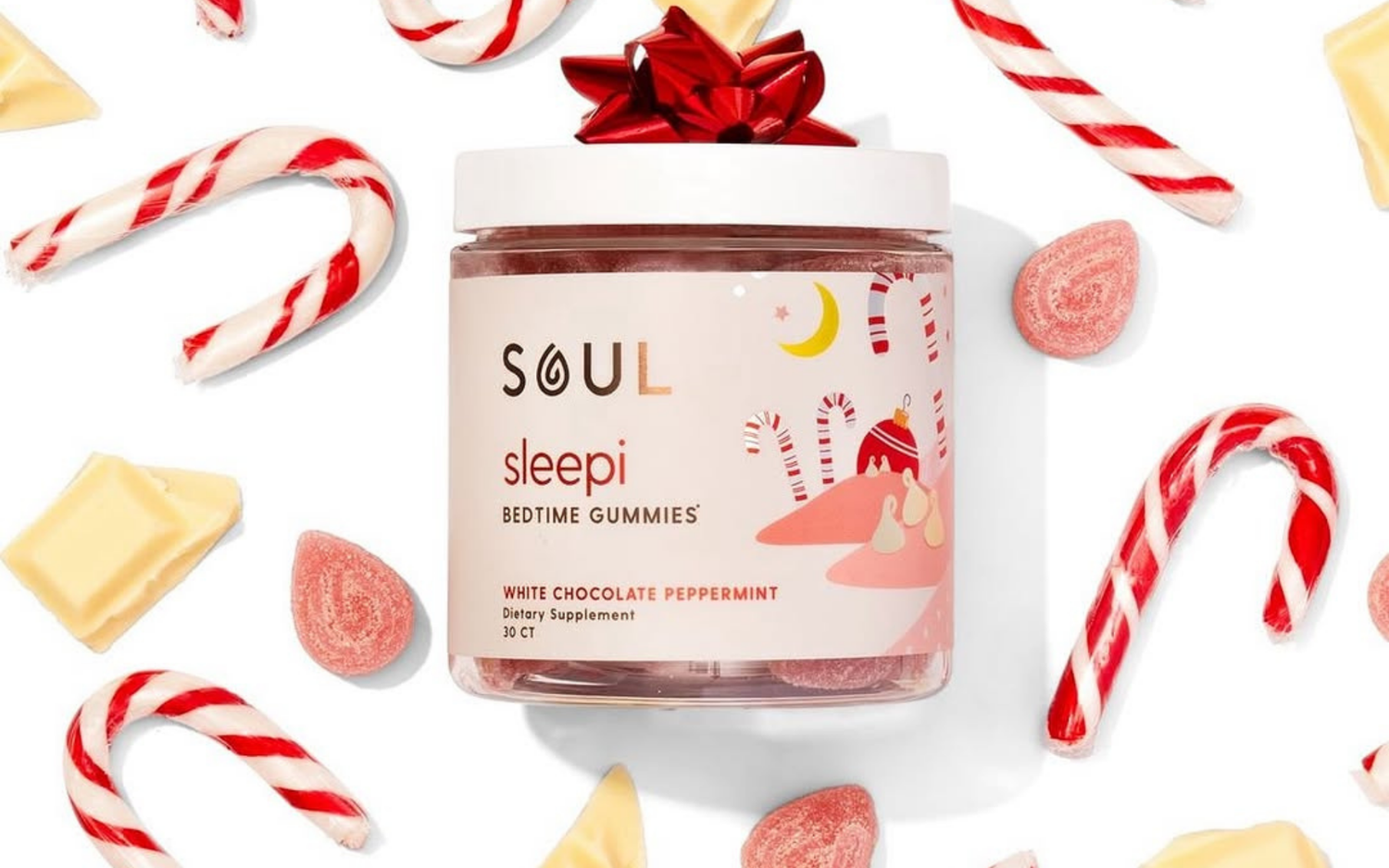 Front view of SOUL Sleepi Bedtime Gummies jar showing white chocolate peppermint label with candy canes and candies on a white background