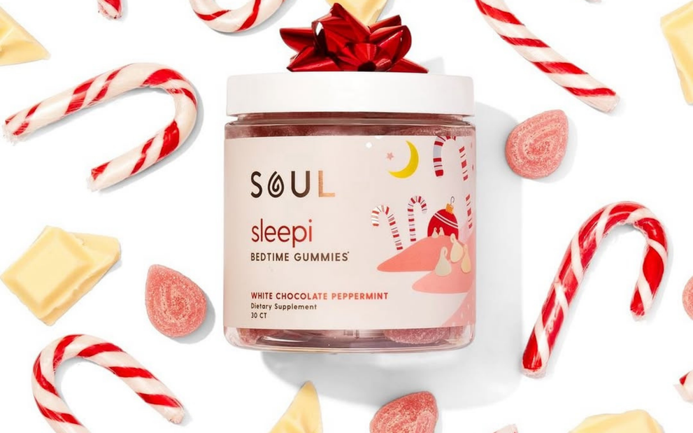 Front view of SOUL Sleepi Bedtime Gummies jar showing white chocolate peppermint label with candy canes and candies on a white background