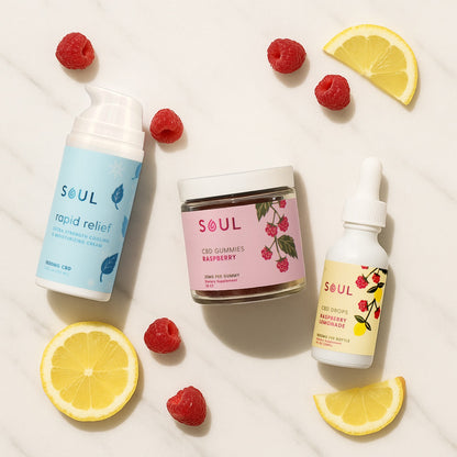 Flat lay of Healthline Select Bundle: blue Rapid Relief pump, jar of raspberry CBD gummies, and Raspberry Lemonade CBD drops on marble