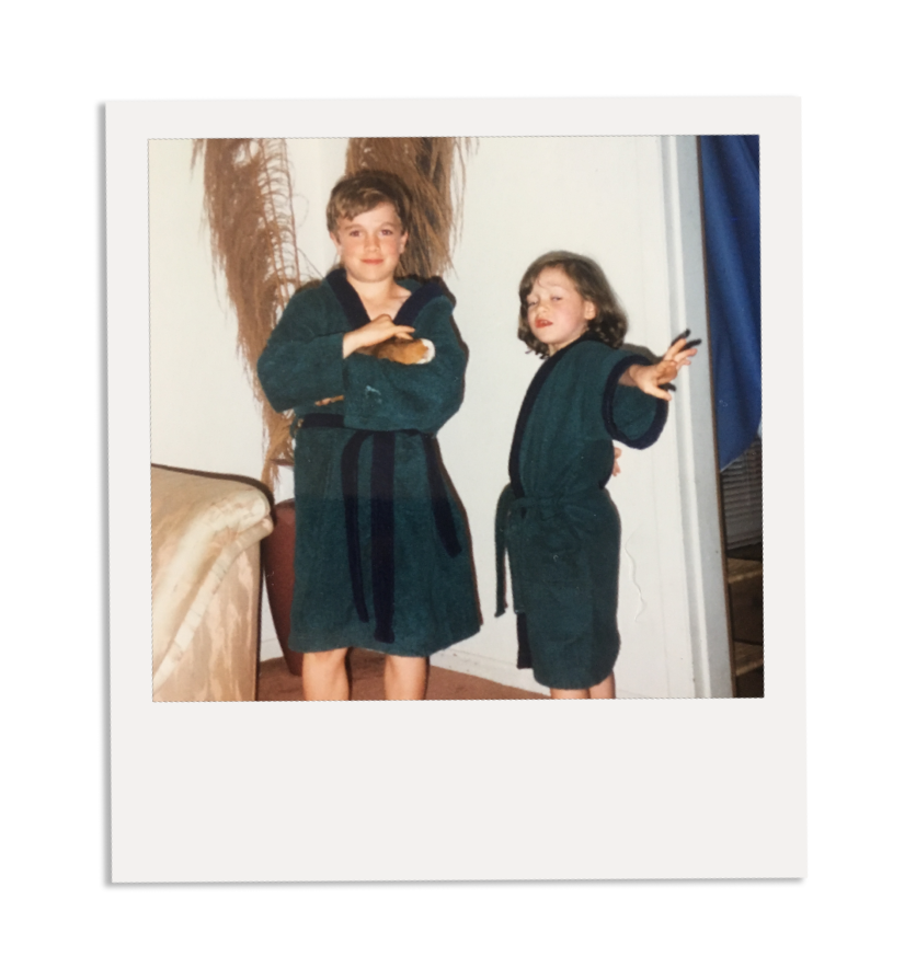 A boy and a girl in bathrobes are standing next to each other